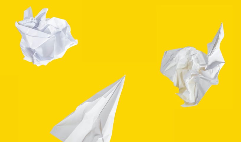 Crumpled pieces of paper on a yellow background